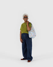 Load image into Gallery viewer, Person holding a patterned bag against a white background